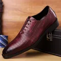 Men's burgundy oxfords with crocodile embossed texture on a rustic wooden background - EU 38 / Red