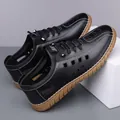 Men's hollow leather slip-on shoes in black with breathable holes and brown rubber sole - Black Hollow