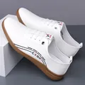 Men's white slip-on leather sneakers with brown rubber sole and side stripe design - 38 / White Unlined
