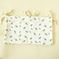 Detail of floral cotton crib organizer with two storage pockets and tie-on ribbons - Eyelash Small Flower