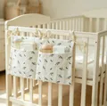 Detailed view of cream cotton double-pocket baby crib organizer with floral print and ties - Eyelash Small Flower