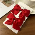 Pair of vibrant red satin bow hair clips for girls displayed on a white product card - Satin Bow / 2 Pcs/Set / Red