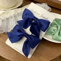Pair of dark blue satin bow hair clips for girls displayed on a white product card - Satin Bow / 2 Pcs/Set / Navy Blue