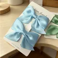 Set of two light blue satin bow hair clips for girls on a jewelry card display - Satin Bow / 2 Pcs/Set / Blue