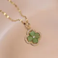 Golden four-leaf clover necklace featuring green heart-shaped stones and zircons - Green Heart Cat Eye Stone Four-leaf Clover Pendant Necklace (X0488)