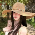Straw sun hat with wide wavy brim and decorative starfish band for beach vacations - Khaki Starfish Hat (D-578)