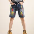 Men's blue distressed denim shorts with artistic paint splatter and ripped details - EU 38 / Denim Blue Splatter Style (TC266)
