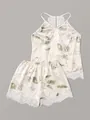 Dettaglio del pigiama in raso con stampa a foglie e raffinato bordo in pizzo bianco - Taglia S / Top E Pantaloni / Stampa di Foglie