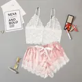 Two-piece women's pajama set with white lace camisole top and pink satin shorts - S / Pink