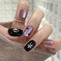 Macro detail of short lavender cat eye and black glossy press-on nails with star patterns - Box Packaging
