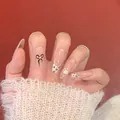 Détail de faux ongles ovales longs avec nœud, motif léopard et empreinte de chat - M / 10 Pièces / Nœud Patte de Chat (BY1937)