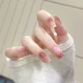 Glossy gradient pink square press-on nails shown on model hand with soft aesthetic - Phototherapy Glue Style