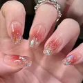 Detail of red blush gradient press-on nails with sparkling gold glitter and sequins - Sugar Color Sequins