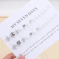 Sparkly silver and white press-on toenails with rhinestones set on a display card - Phototherapy Glue Style