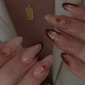 Deep red and nude almond press-on nails with gold embossed lines and sparkling rhinestones - Glue Type