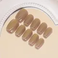 Dettaglio di 10 unghie finte jelly nude lucide posizionate su uno specchio - Aurora Arancione (BY1450) / Stile Colla Gel UV (ai-30 Pezzi/Confezione) / Arancione
