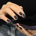 Macro shot of glossy deep blue press-on nails with a square-oval shape on hands - Deep Blue (Liquid Glue)