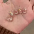 Detail of Christmas press-on nails with cat-eye glitter and snowflake pearl decor - Winter Song (Liquid Glue)