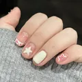 Detail of milky white press-on nails with pink stars, heart patterns and rhinestones - Phototherapy Glue Style / Elegant Breeze (BY1181)