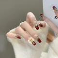 Detailed view of handmade coffin nails with deep red finish, gold foil, and 3D bow accent - Soft Flower (Liquid Glue)
