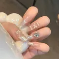 Press-on nails with nude pink base, french tips, pearl bows, and sparkling rhinestones - Gold Plated Top Coat Glue Style / Vermilion Gold Style (BY1165)