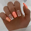Short orange press-on nails with glitter, white V-shaped French tip and rhinestones - Gold Plated Top Coat Glue Style
