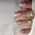 French tip press-on nails in nude pink with gold lines and minimalist rings - French Jade Style (With Glue)