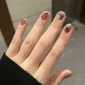 Brown cat-eye press-on nails with silver glitter and black leaf patterns, short round shape - Brown Gradient Silver Glitter Black Leaf Style (BY1348)