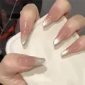 Detail of long stiletto press-on nails with nude pink base and silver cat-eye gradient - Dazzling Style