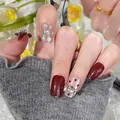 Press-on nails in deep red with holographic glitter and silver 3D bow accents - Box Packaging / Wine Red Patchwork