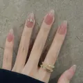 Nude pink gradient press-on nails with jelly finish and rhinestone accents on oval shape - Boxed Style