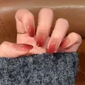 Close-up of almond-shaped ombre press-on nails with red gradient and glitter finish - Classic and Graceful Style (BY1886) / Prefabricated Nail Strip