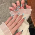 Detailed view of almond blue cat-eye press-on nails with heart gemstone and pearls - M / Blue Cat Eye Heart Gem Pearl Style (BY1635)