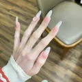 Detail of long almond press-on nails with pink blush gradient and 3D heart jewel - 30 Pcs/Box / Pink Gradient 3D Decor (BY1473)