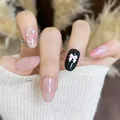 Short oval press-on nails with pink checkered patterns and a 3D bow accent - Blooming Lotus (BY2225)