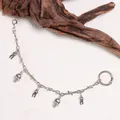 Silver punk shoe chain with skull and tooth charms featuring a barbed wire style link - Skull Teeth Style