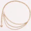 Macro shot of gold layered chain belt featuring an intricate coin pendant detail - Gold