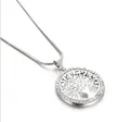 Detail shot of a silver tree of life pendant with sparkling crystal embellishments - Necklace / Silver