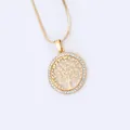 Close-up of golden Tree of Life pendant with white rhinestones and snake chain necklace - Necklace / Gold