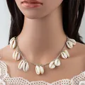 Bohemian silver chain necklace with eleven white natural shells shown on a model - Fine Style / Thin Chain Silver