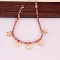 Close-up of golden butterfly charms and pink rhinestones on a stylish anklet jewelry - Gold (Pink Stone)