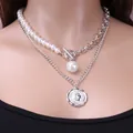 Silver layered baroque pearl necklace with coin pendant and toggle clasp on model - Silver