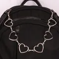 Silver metal heart link chain accessory hanging on a black backpack for bags - Six Hearts Single Layer Bag Chain
