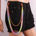 Close-up of vibrant candy-colored acrylic double-layer chain on black denim shorts - Orange