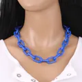 Chunky blue acrylic chain necklace in hip hop punk style on a white ribbed shirt - Blue