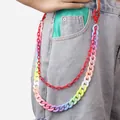 Detail showing double-layered colorful resin pants chains on denim jeans for street style - Red