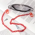 Detail view of red acrylic eyeglass chain with lobster clasps and rubber loops - Red