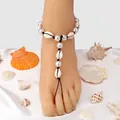 Bohemian shell and pearl toe ring anklet with black braided cord on satin background - Black Cord Woven Shell Style / Black