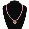 Rainbow heart pendant necklace with colorful clay beads on a black mannequin display - Large Heart Necklace / Red