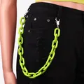 Detail of neon green chunky acrylic chain link on black jeans for punk street style - Green